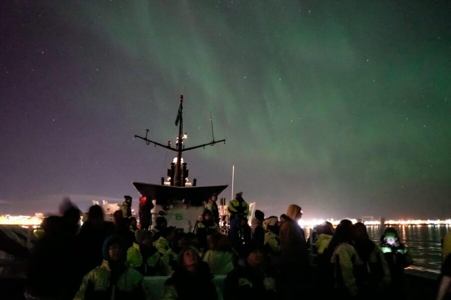 Reykjavik: Northern Lights Guided Boat Tour with Photos - How the Crew Finds Darker Skies for Aurora Viewing